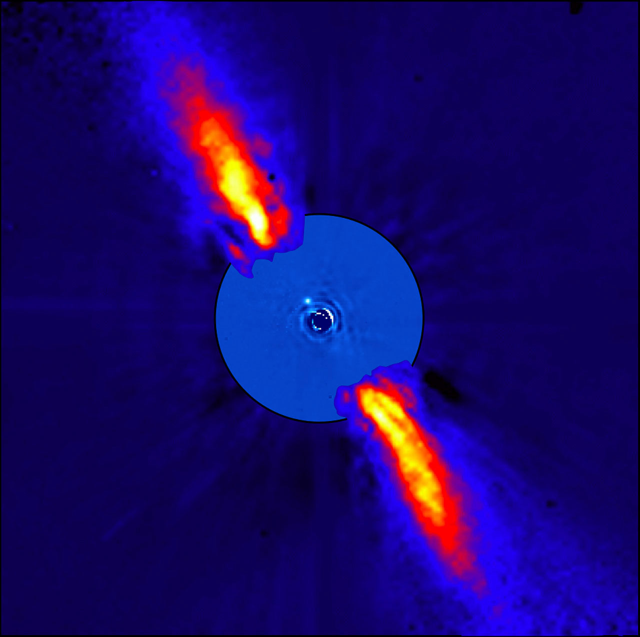 An exoplanet is seen as a tiny dotof light blue light next to a str that has been masked with a screen. Protruding from both sides are bright, yellow-orange jets. Those indicate the disk of debris.