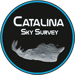 On a black circle with a blue outline the words Catalina Sky Survey appear in white capital letters. Beneath the words we see a rocky, irregular grey asteroid, lit from below.