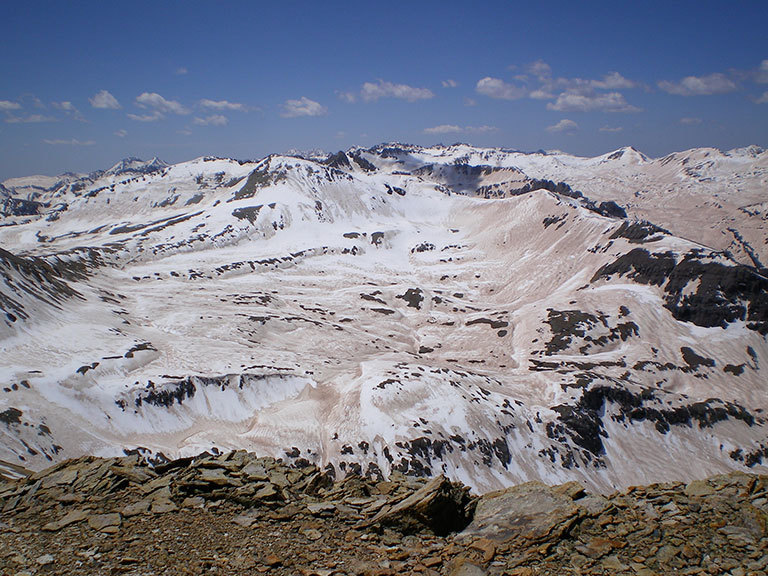 A photograph of the extreme dust deposition from the deserts of the Colorado Plateau onto the Colorado Rockies snowpack in 2009. Taken from the high point of the Senator Beck Basin in the San Juan Mountains, it captures the extent of the impact of darkening in which the snow albedo dropped to about 30%, more than doubling the absorption of sunlight. Credit: S. McKenzie Skiles, Snow Optics Laboratory, NASA/JPL. View larger image.