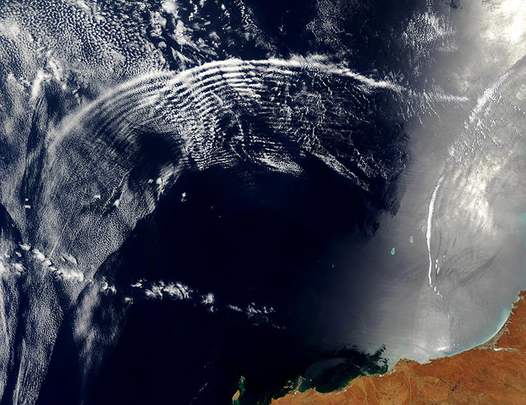 Two unique types of waves ripple through the Indian Ocean in this spectacular true-color Moderate Resolution Imaging Spectroradiometer (MODIS) image, taken by the Terra satellite on November 11, 2003. Credit: Jacques Descloitres, MODIS Rapid Response Team, NASA/GSFC. Learn more about and download the image.