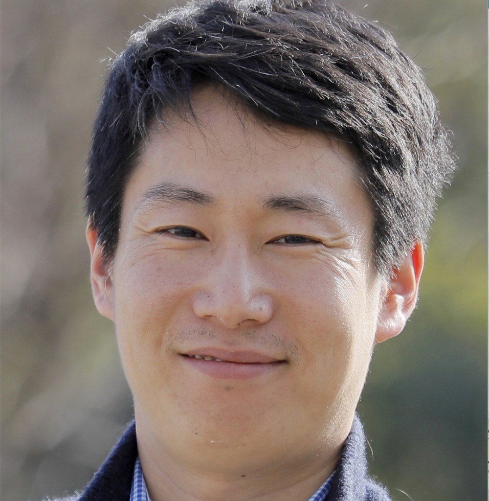 Portrait photo of a smiling man with dark hair