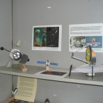 A "John Jogerst modification" paper model of the James Webb Space Telescope shown on the right. A Hubble Space Telescope model is also shown on the left, as well as two other unidentified spacecraft models.