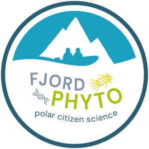 A grey-blue circle surrounds the words "Fjord Phyto polar citizen science." These words curve, as if they are sitting on top of ocean waves. Above the text, filling the top third of the circle, there is an ice blue shape with the white cut-out of a tall mountain. The blue shape wraps under the mountain and outlines two people in a blue boat. Around the text we see two cartoon phytoplankton. The one on the left is a short section of a double-helix. The one on the right is a short cylinder with spines jutting out from each end.