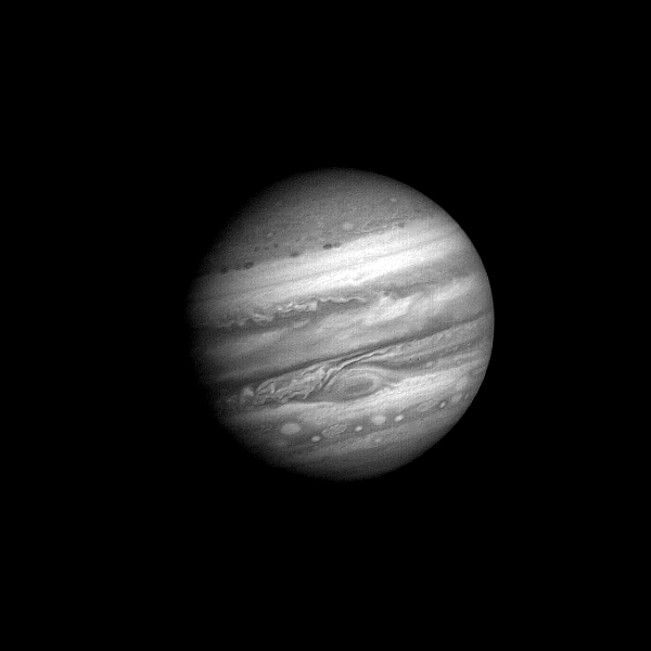 An animated GiF shows Jupiter moving closer, its clouds, rotating in this montage of Voyager shots.