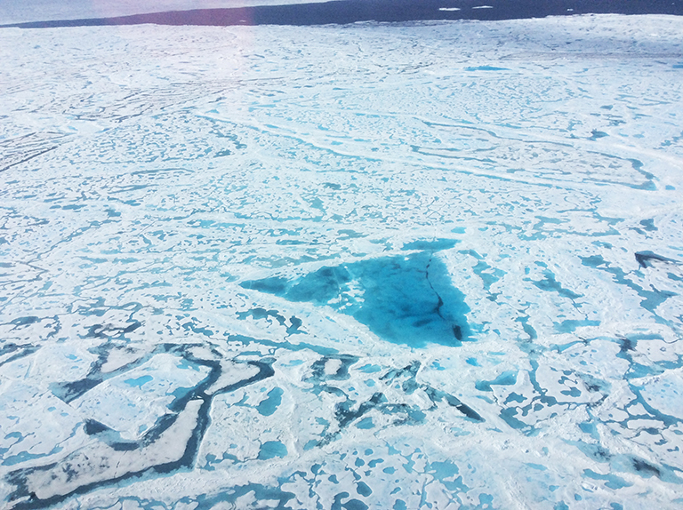 A large pool of melt water over sea ice.