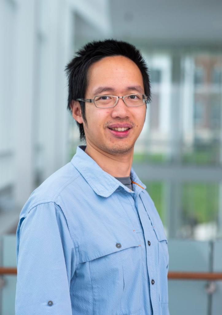 Portrait photo of a man standing in a lab.