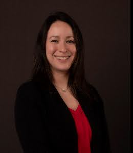 Portrait photo of a smiling woman with long dark hair