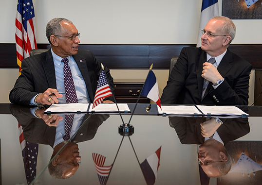 NASA Administrator Charles Bolden, left, and Centre National d'Études Spatiales (CNES) President Jean-Yves Le Gall talk after signing an agreement to move from feasibility studies to implementation of the Surface Water and Ocean Topography (SWOT) mission at NASA Headquarters in Washington. The SWOT mission will use wide swath altimetry technology to produce high-resolution elevation measurements of the surface of lakes, reservoirs and wetlands and of the ocean surface. Image credit: NASA/Bill Ingalls