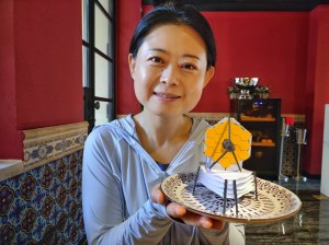 Woman holding a JWST model she built.