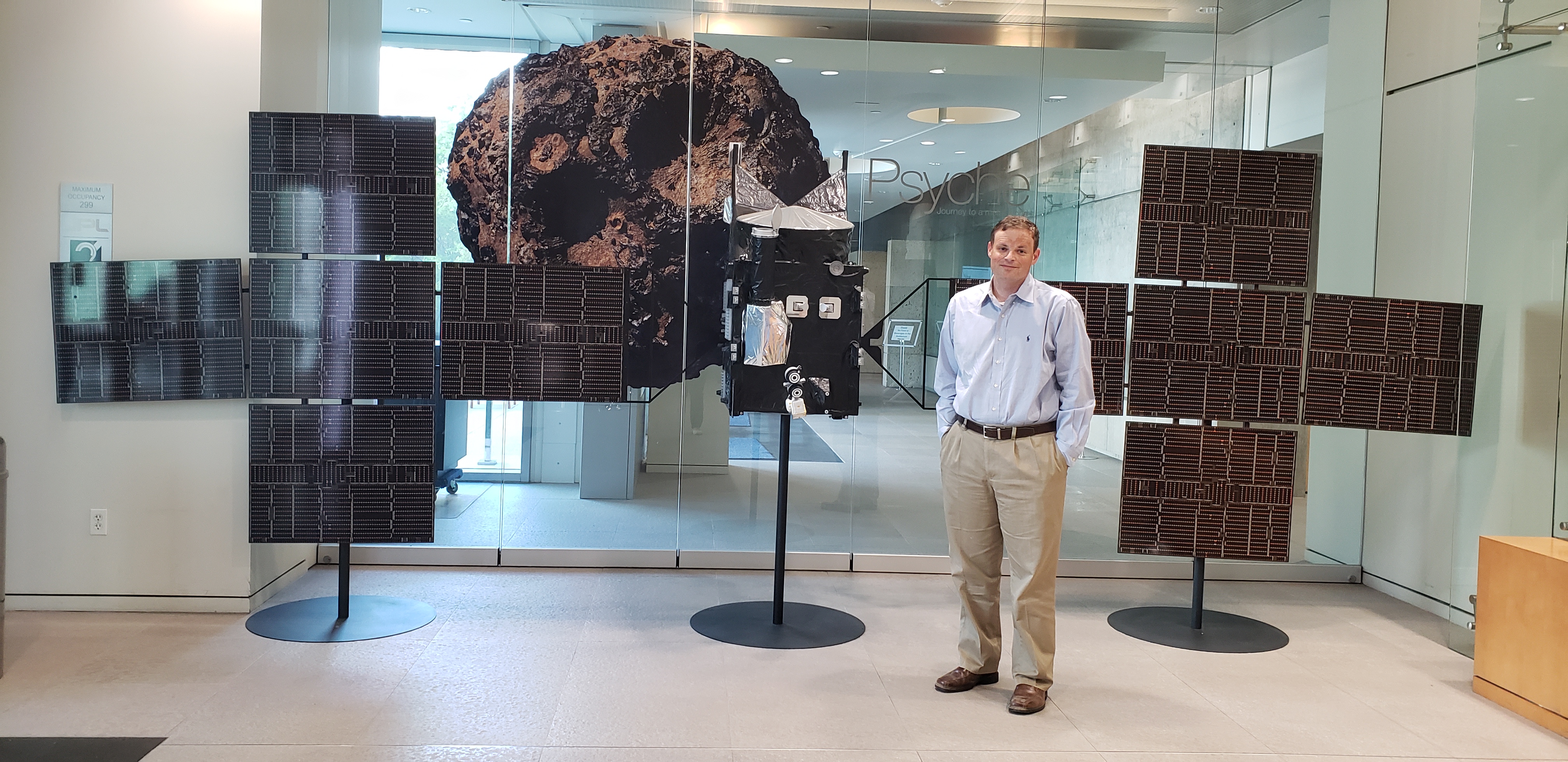 Man standing in front of a spacecraft model
