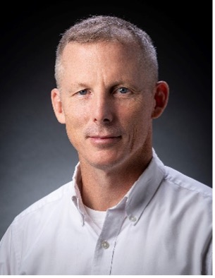 head shot of short-haired man in white button-down shirt