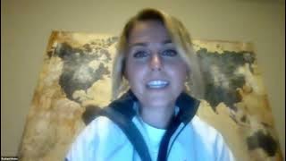 Video still frame of a woman with blonde hair talking