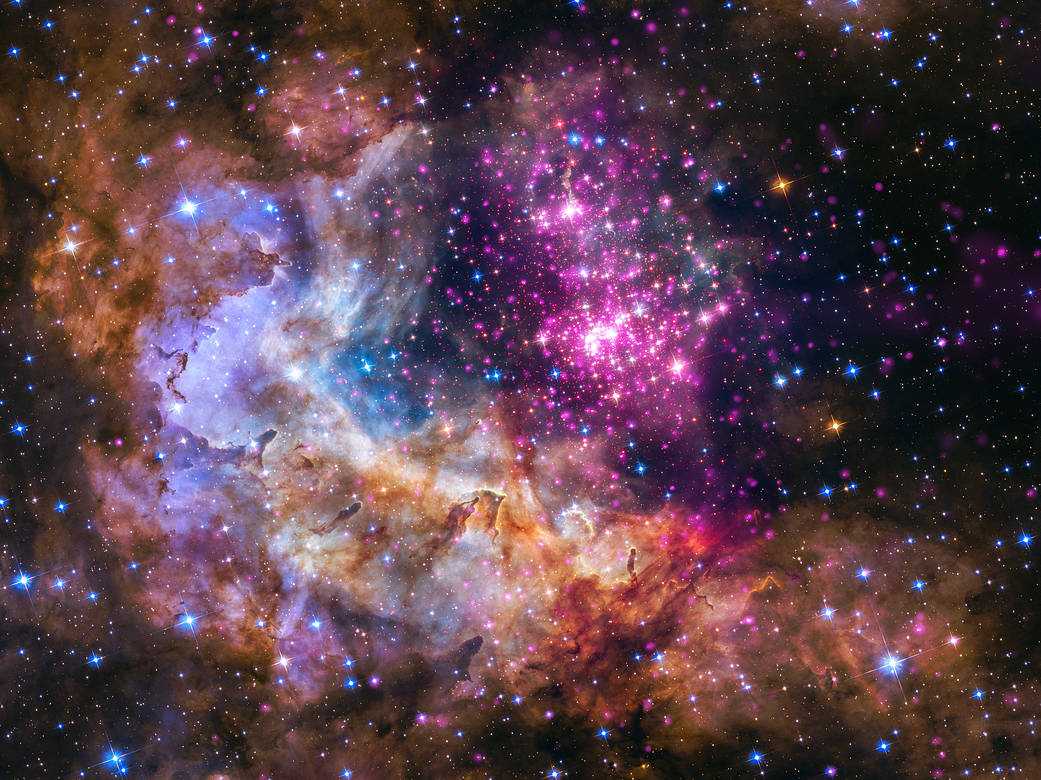Hubble Space Telescope data are shown in green and blue; Chandra data are shown in purple. Together they form a brilliant cluster of stars among clouds where stars form.