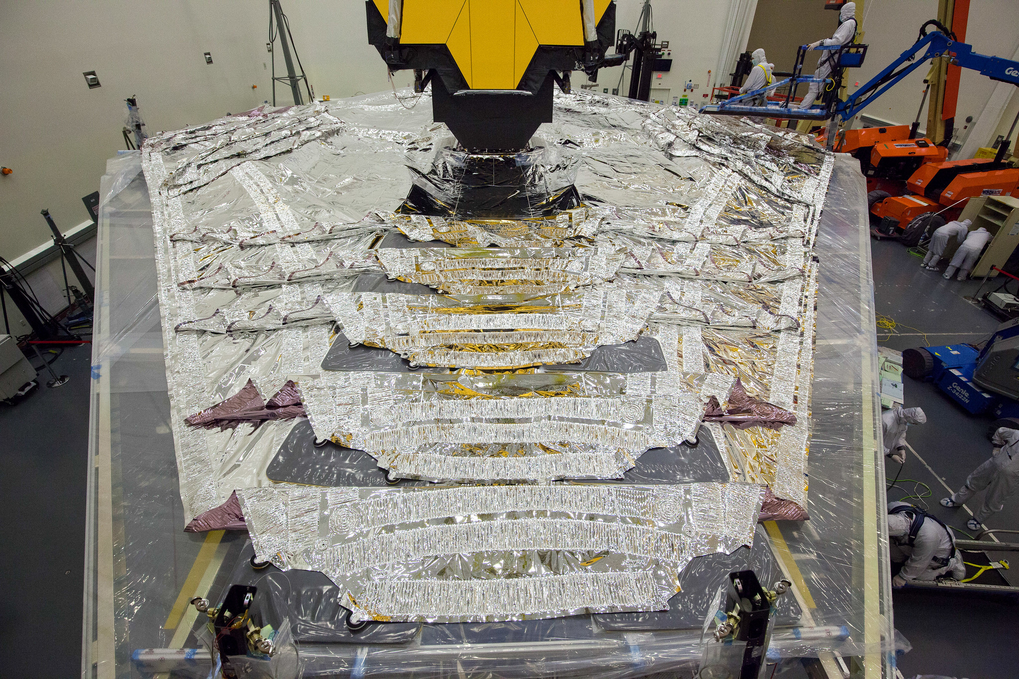 Webb in the clean room an Northrup Grumman for final integration and test. with the 5 sunshield layers laid flat on a supporting structure