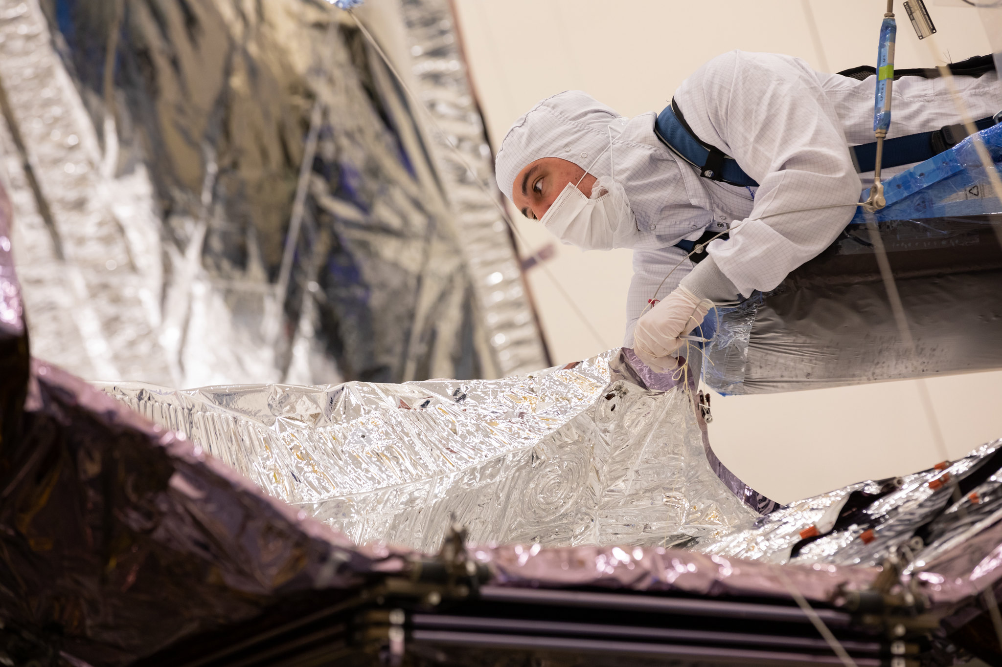 In this archival image from January 2021, technicians and engineers work on the James Webb Space Telescope, preparing its sunshield to be folded. The sunshield fold was accomplished in April 2021. Read all about this milestone: