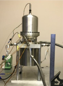 Two silver cylinders bristle with wires and tube.