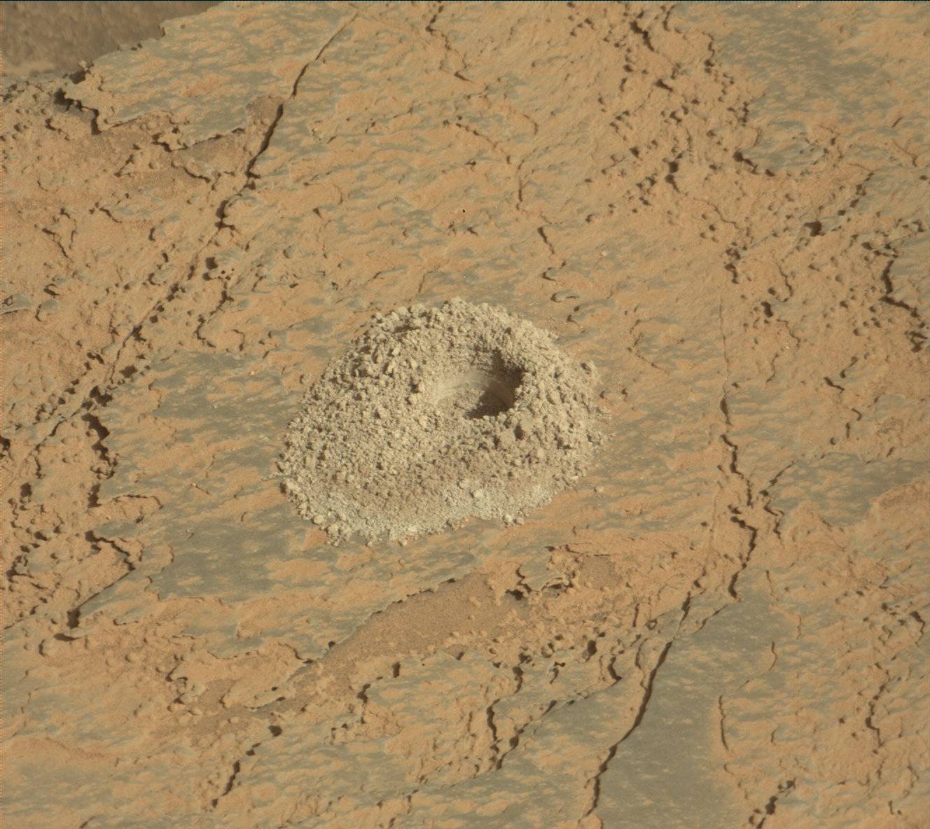 A hole in the surface of Mars created by the Curiosity rover