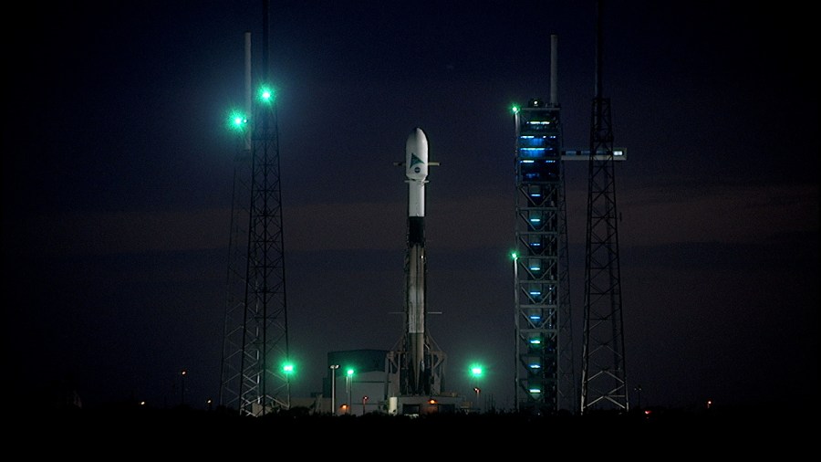 A SpaceX Falcon 9 rocket topped with NASA's PACE (Plankton, Aerosol, Cloud, ocean Ecosystem) spacecraft inside a protective payload fairing is raised vertical at Space Launch Complex 40 at Cape Canaveral Space Force Station in Florida.