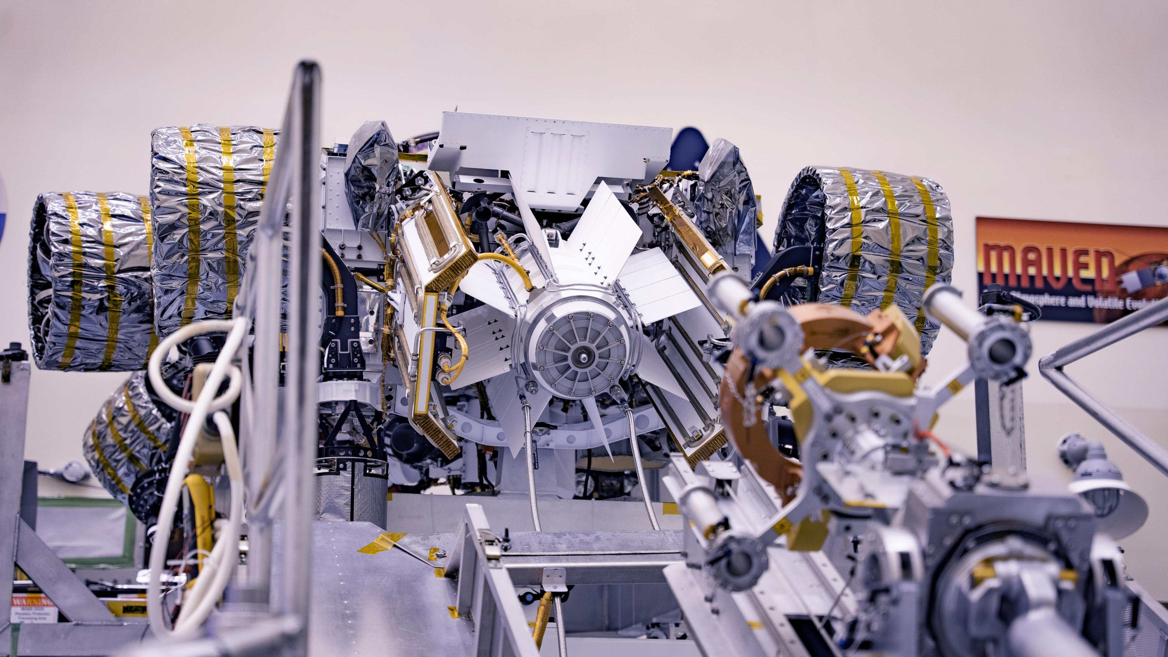 The rover is upside down in this straight from the back view. The image is centered on a cylinder with fins, the spacecraft's Radioisotope Thermoelectric Generator.