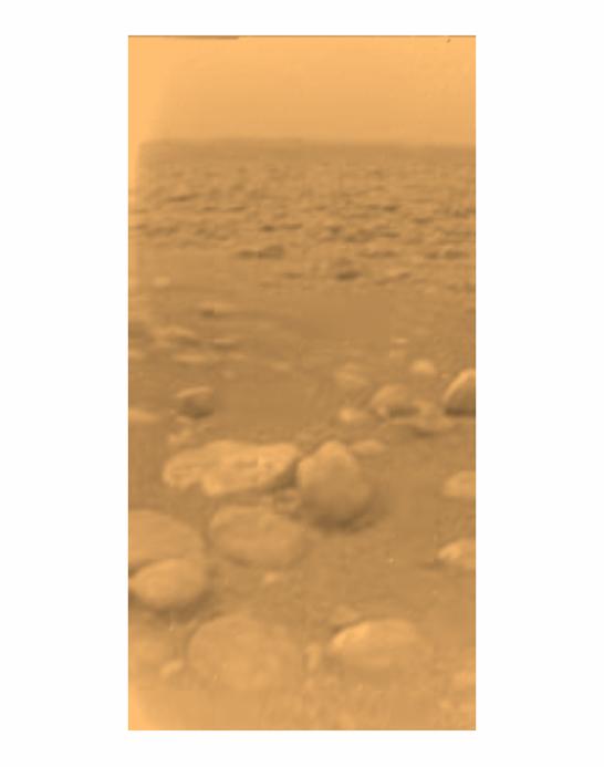 Small rocks dot the surface in this hazy reddish view of the surface of Titan.