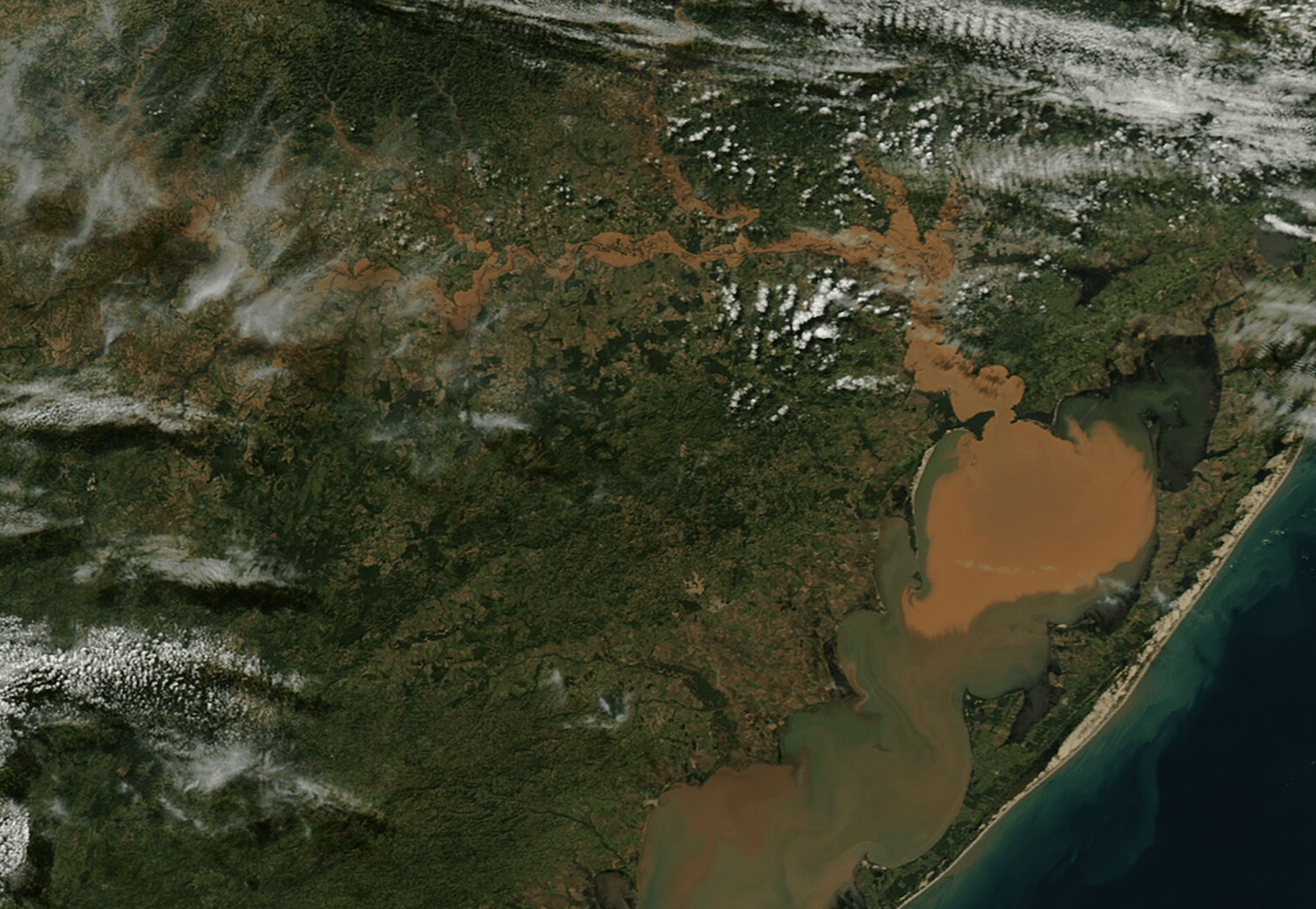 An image shows severe flooding in southern Brazil with muddy floodwater.