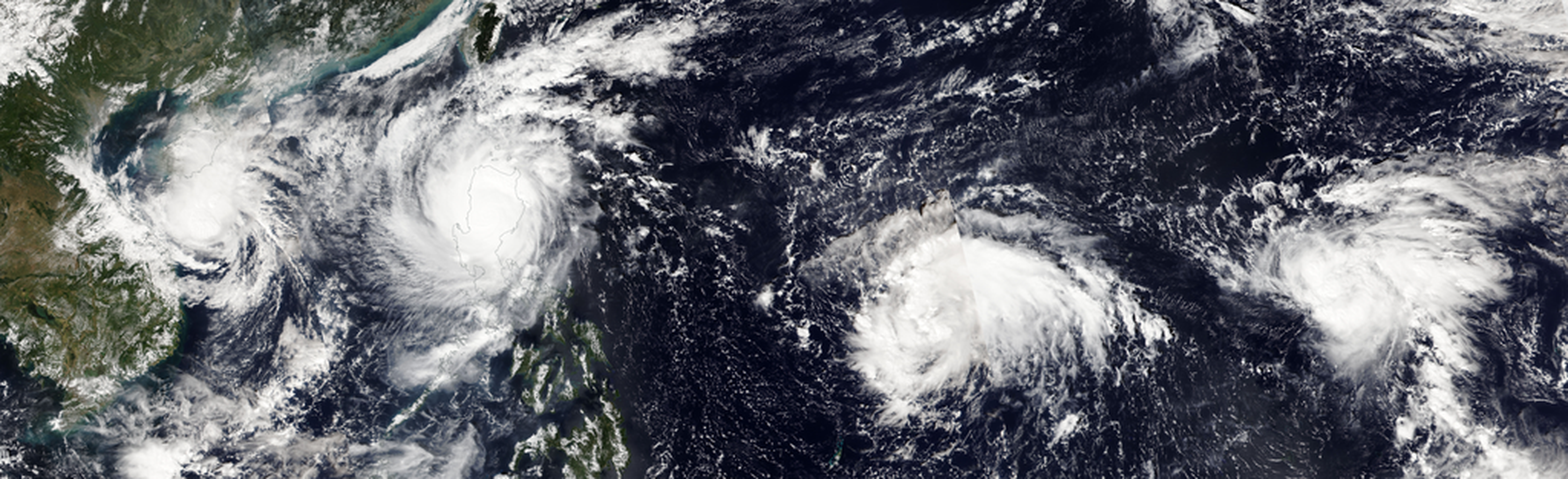 An image of four tropical storms in the western pacific ocean as seen from orbit.