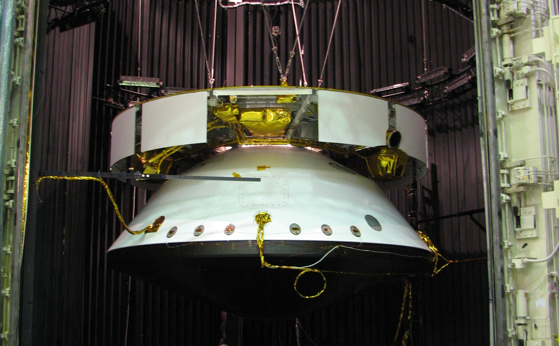 This image shows the Mars Science Laboratory spacecraft is suspended in a dark chamber, awaiting an environmental test.