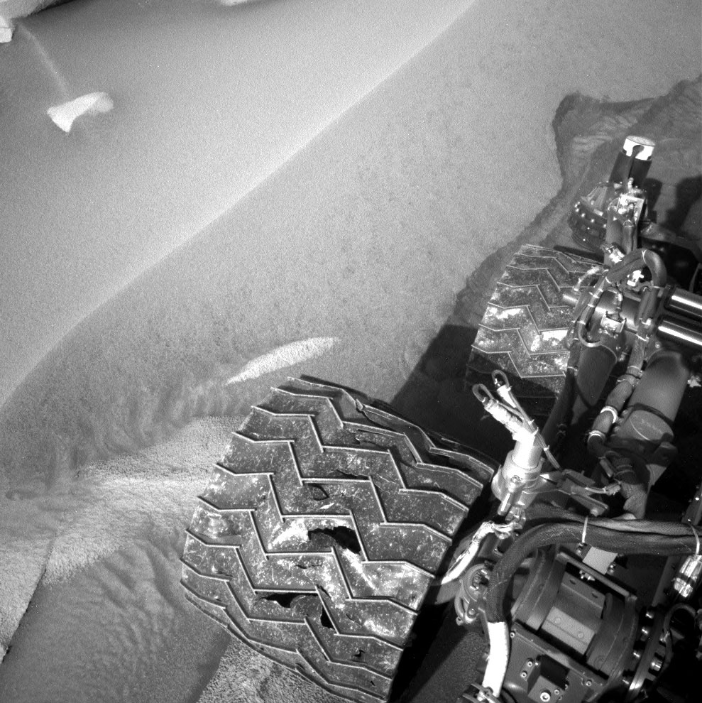 Navcam image of Curiosity's right-middle and right-rear wheels.