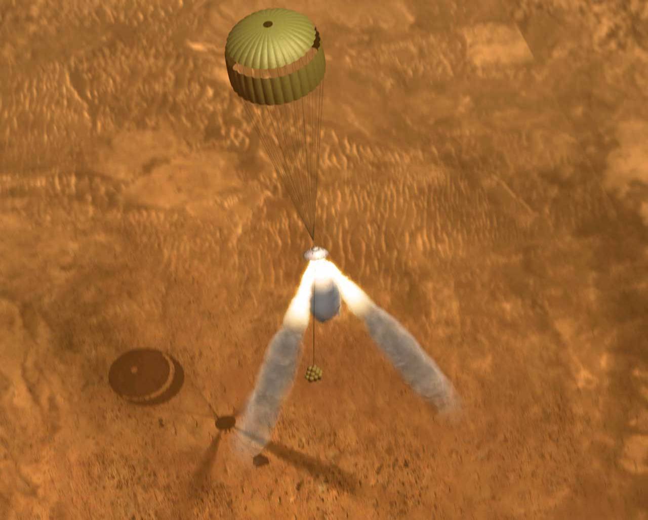 With the parachute deployed, three retrorockets fire their engines, suspending the lander 30 - 50 feet above the Martian surface.