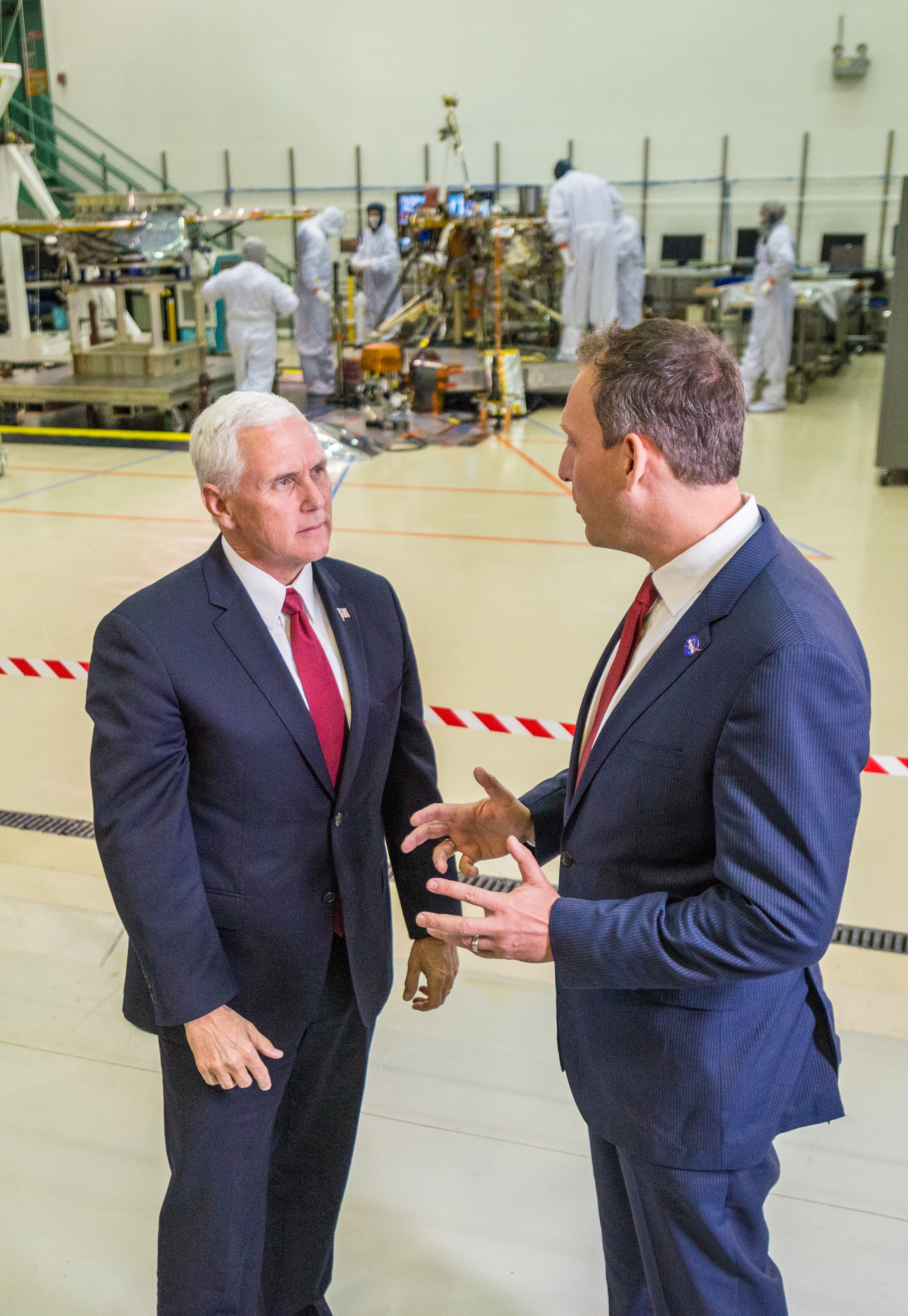 Vice President Mike Pence, left, speaks with Thomas Zurbuchen, NASA's associate administrator for the Science Mission Directorate, right, in a clean room facility near Denver, Colorado, where Lockheed Martin Space Systems is assembling and testing InSight, NASA's next spacecraft to Mars.