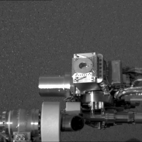 This image taken at Meridiani Planum, Mars, by the panoramic camera on the Mars Exploration Rover Opportunity shows the rover's Moessbauer spectrometer (circular device in center), located on its instrument deployment device, or "arm." The image was acquired on the ninth martian day or sol of the rover's mission.