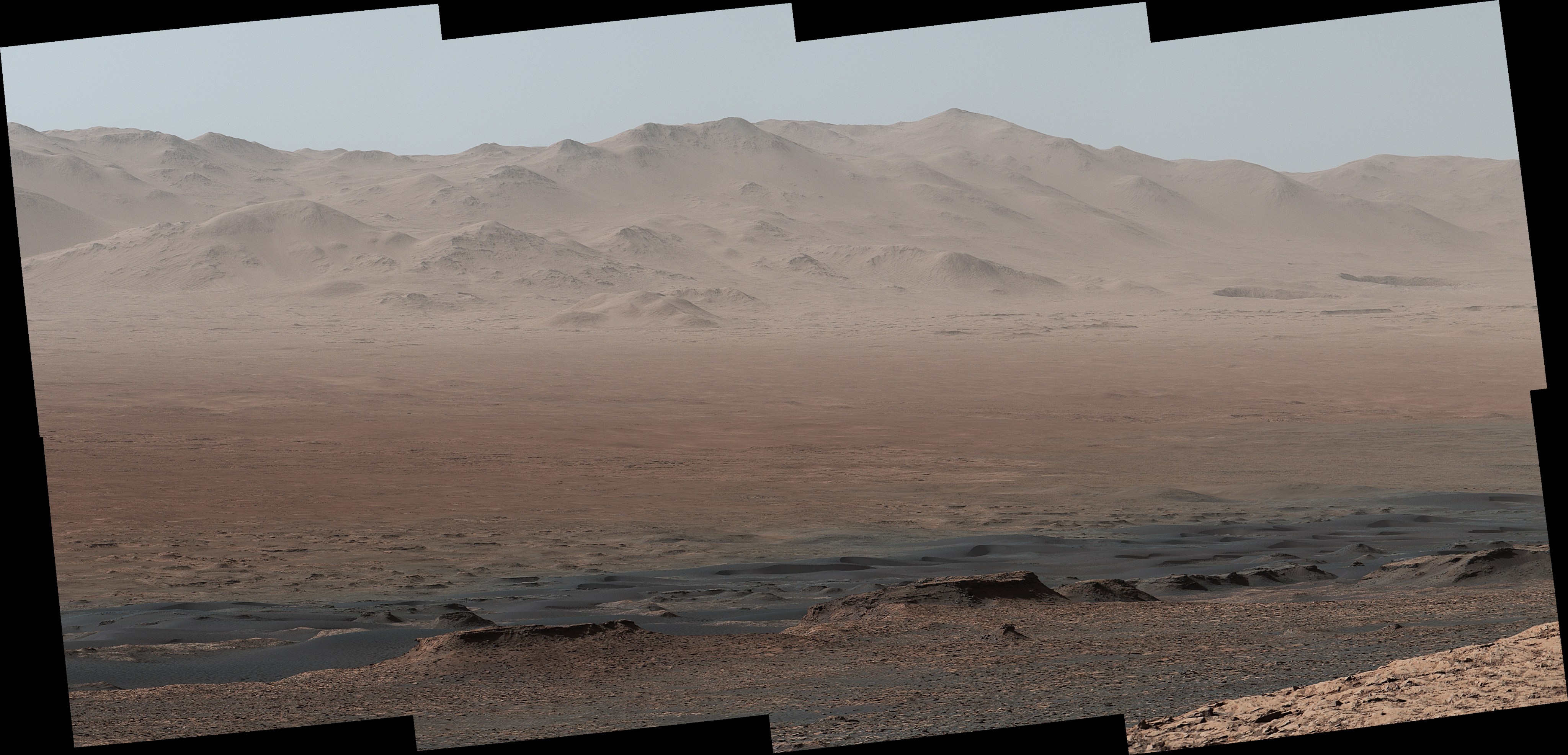 A viewpoint on "Vera Rubin Ridge" provided NASA's Curiosity Mars rover this detailed look back over the area where it began its mission inside Gale Crater, plus more-distant features of the crater. The right-eye, telephoto-lens camera of the rover's Mastcam took the component images Oct. 25, 2017.