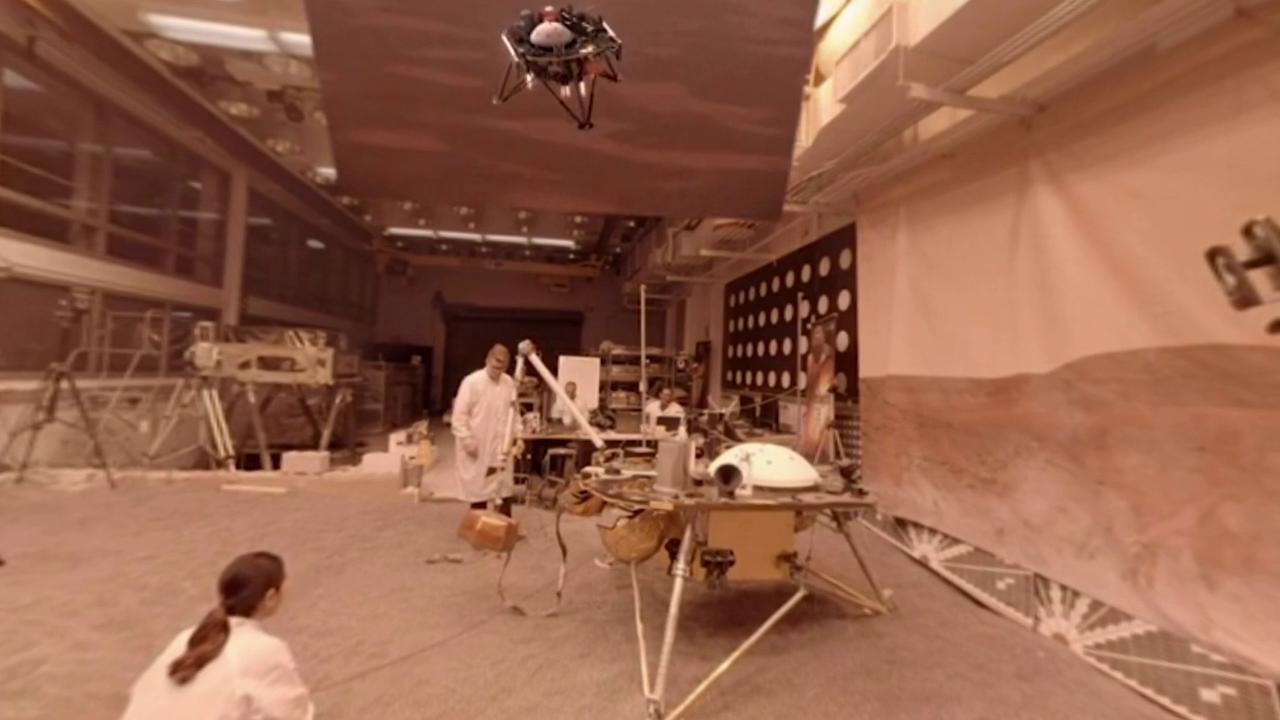engineers in lab with spacecraft