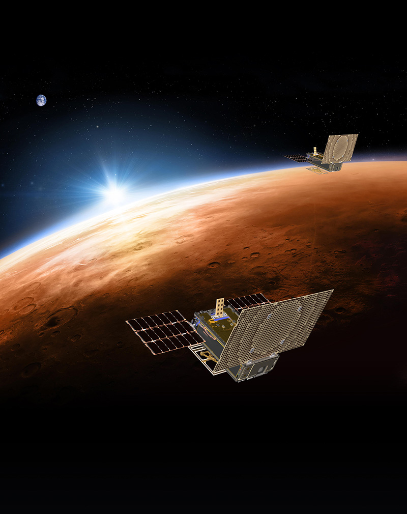 An artist's rendering of the twin Mars Cube One (MarCO) spacecraft flying over Mars with Earth in the distance.