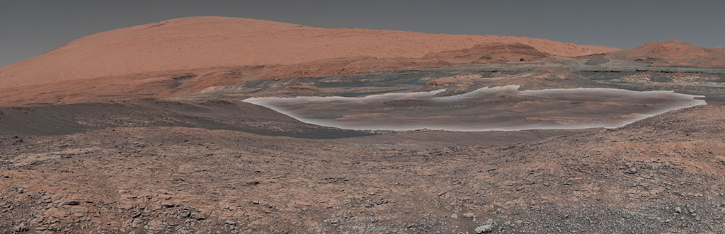 This mosaic taken by NASA's Mars Curiosity rover looks uphill at Mount Sharp, which Curiosity has been climbing.