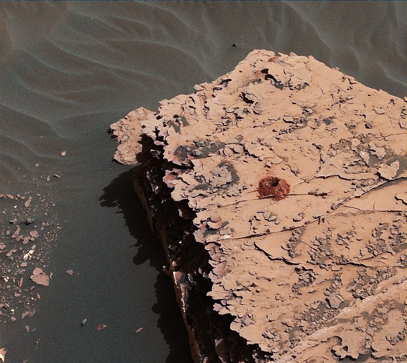 NASA's Curiosity rover successfully drilled a 2-inch-deep hole in a target called "Duluth" on May 20. It was the first rock sample captured by the drill since October 2016. This image was taken by Curiosity's Mast Camera (Mastcam) on Sol 2057.