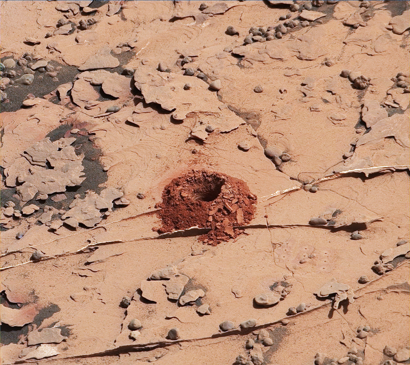 A close-up image of a 2-inch-deep hole produced using a new drilling technique for NASA's Curiosity rover. The hole is about 0.6 inches across (1.6 centimeters). This image was taken by Curiosity's Mast Camera (Mastcam) on Sol 2057. It has been white balanced and contrast enhanced.