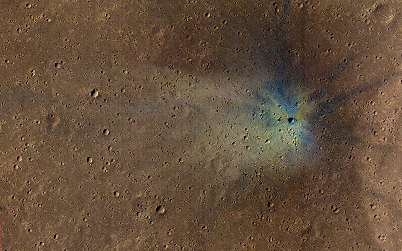 This is an image from NASA's Mars Reconnaissance Orbiter of a new impact site on Mars, within the dense secondary crater field of Corinto Crater.