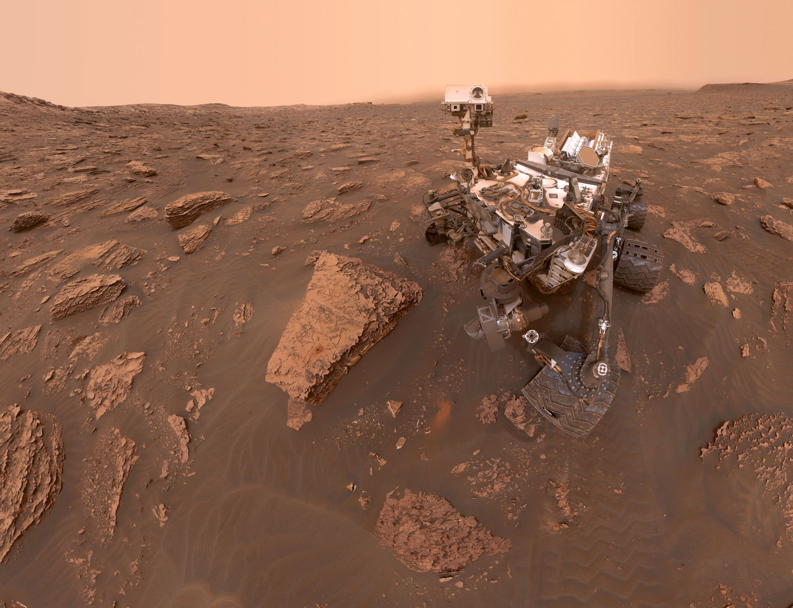 A self-portrait by NASA's Curiosity rover taken on Sol 2082 (June 15, 2018). A Martian dust storm has reduced sunlight and visibility at the rover's location in Gale Crater. A drill hole can be seen in the rock to the left of the rover at a target site called "Duluth."