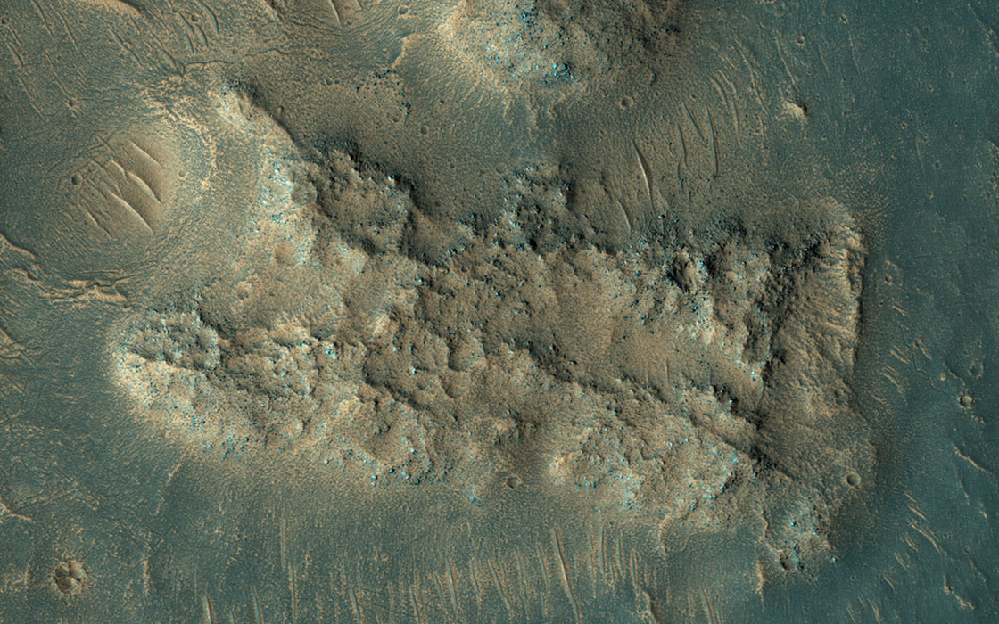 This image, acquired on May 13, 2018 by NASA's Mars Reconnaissance Orbiter, shows sand dunes scouring what appears to be a highly-cratered, old lava flow in the Tempe Terra region, located in the Northern Hemisphere.