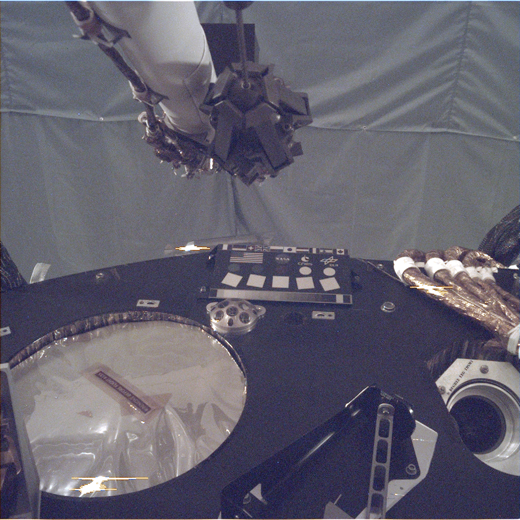 This image of the deck of NASA’s InSight lander – where the camera’s rectangular calibration target can be seen in the middle -- was taken by the Instrument Deployment Camera during the assembly, test and launch operations phase at Lockheed Martin Space, Denver.