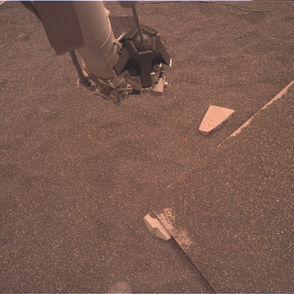 This test image from an engineering model of NASA’s InSight lander shows part of the lander’s robotic arm and the simulated Martian ground at a testbed at NASA’s Jet Propulsion Laboratory in Pasadena, California.