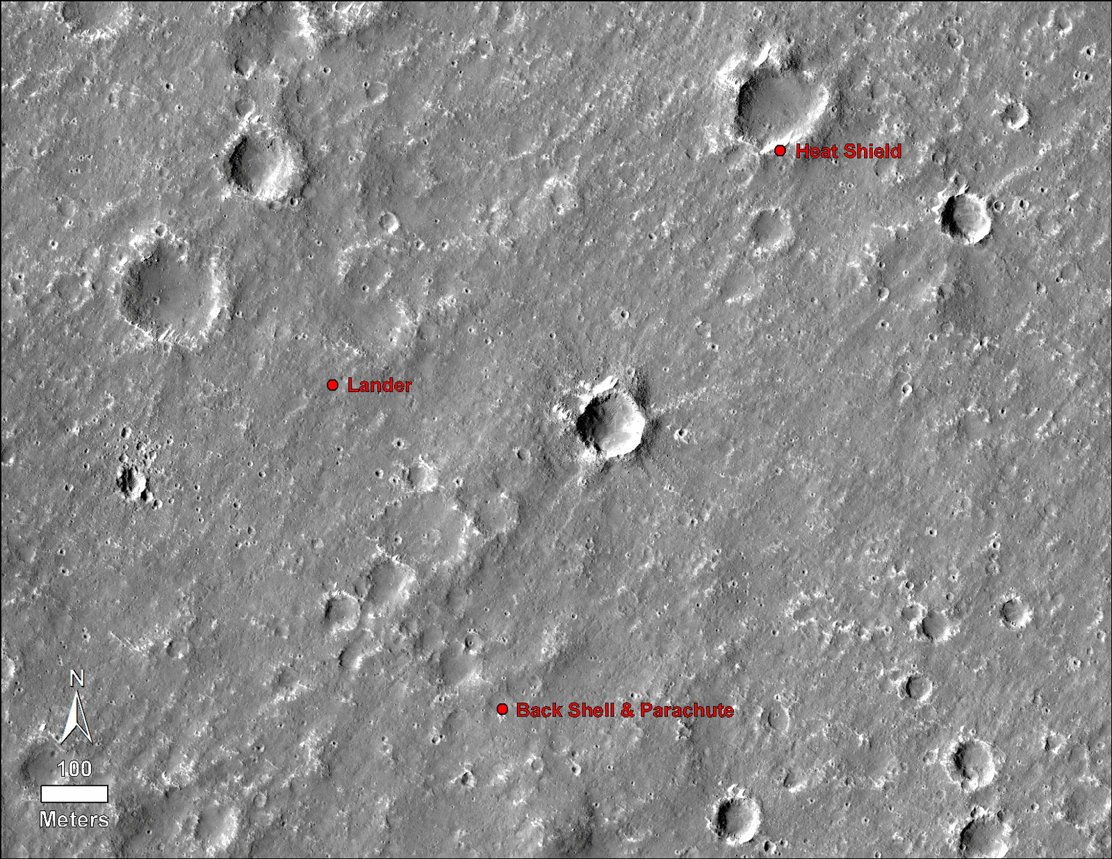 An annotated image of the surface of Mars, taken by the HiRISE camera on NASA's Mars Reconnaissance Orbiter (MRO) on May 30, 2014. The annotations — added after InSight landed on Nov. 26, 2018 — display the locations of NASA's InSight lander, its heat shield and parachute.