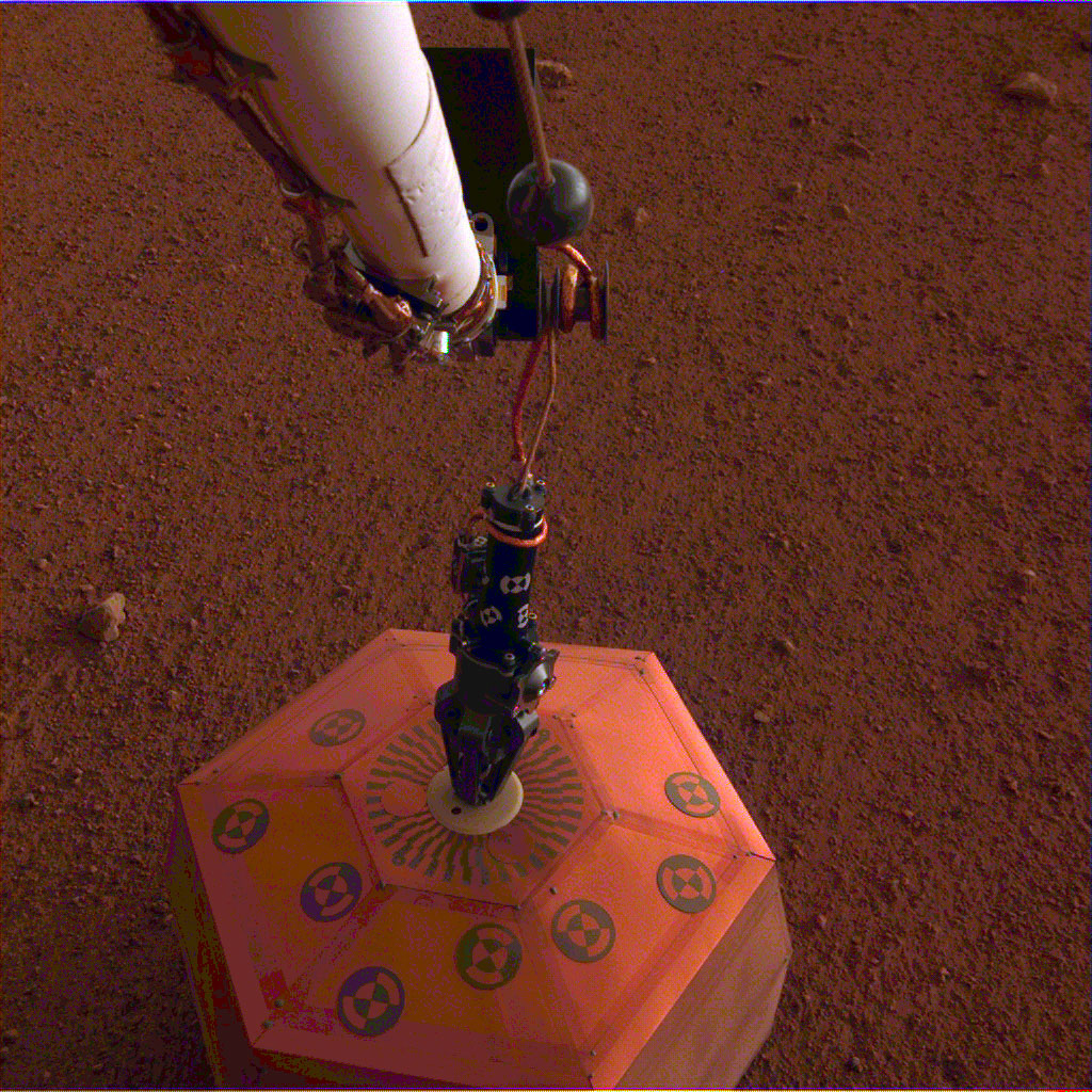 The seismometer is the copper-colored object in this image, which was taken around Martian dusk.