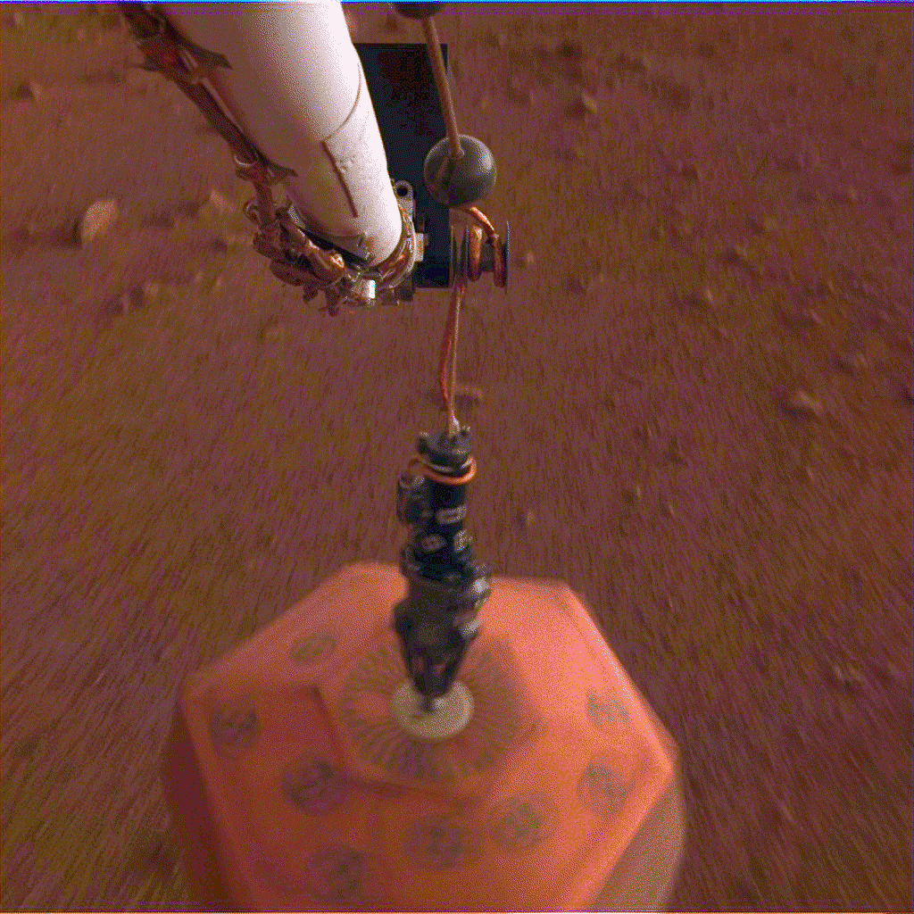 This set of images shows NASA's InSight lander deploying its first instrument onto the surface of Mars, completing a major mission milestone.