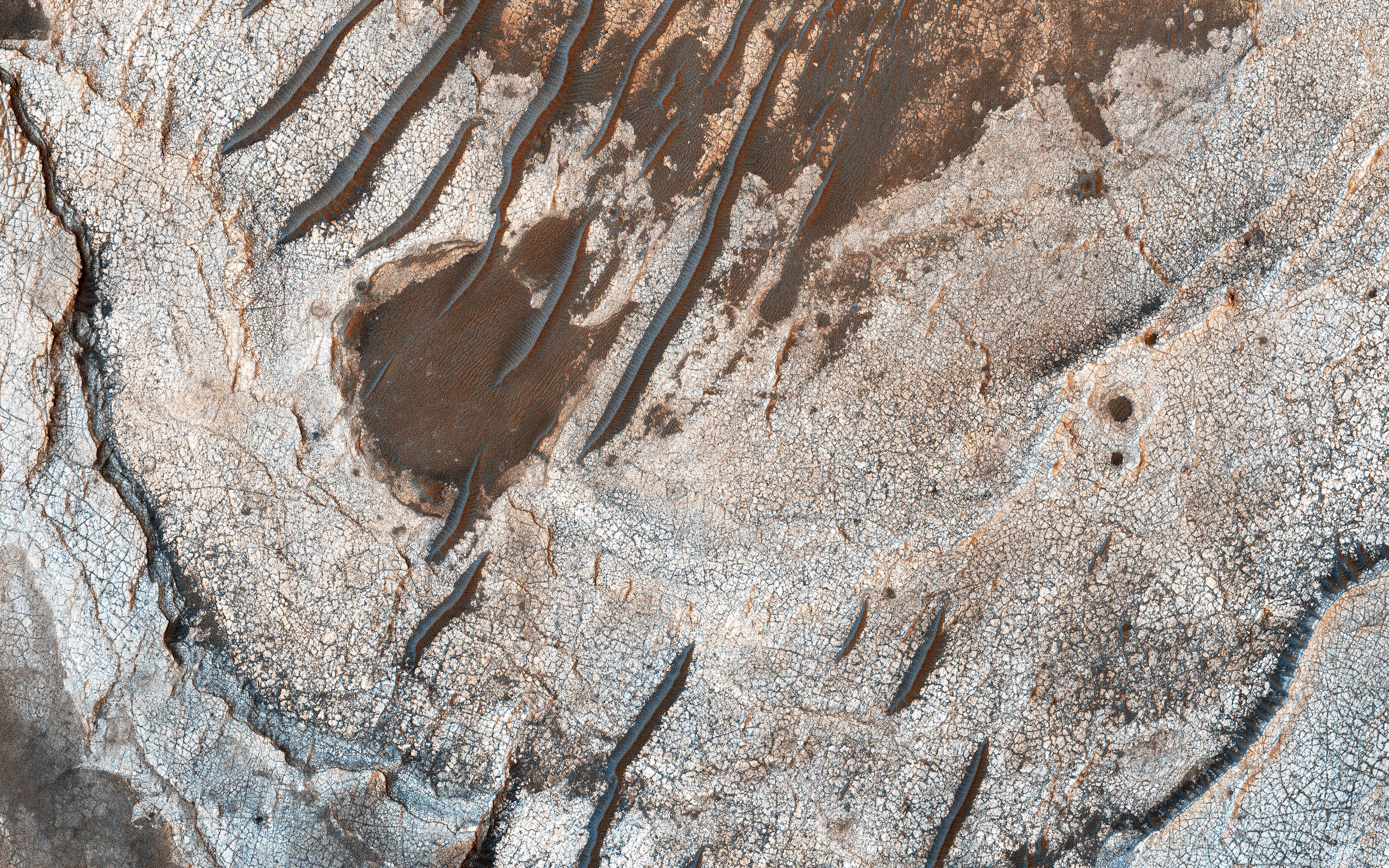 This image acquired on December 8, 2018 by NASAs Mars Reconnaissance Orbiter, shows erosion of the surface revealing several shades of light toned layers, likely sedimentary deposits.