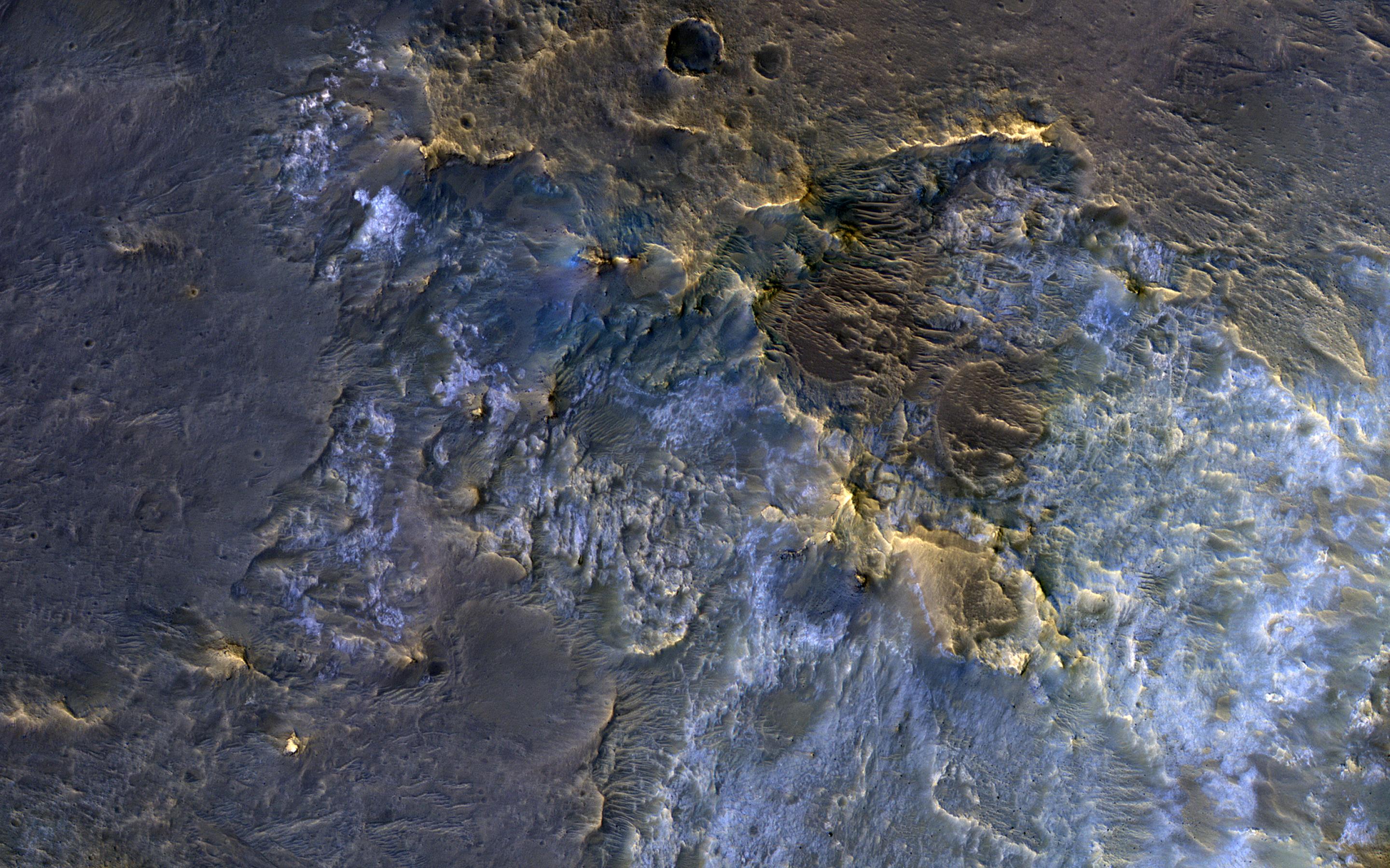 This image acquired on November 30, 2018 by NASAs Mars Reconnaissance Orbiter, shows a complex crater, where we see bedrock in several locations from different depths in the crust.