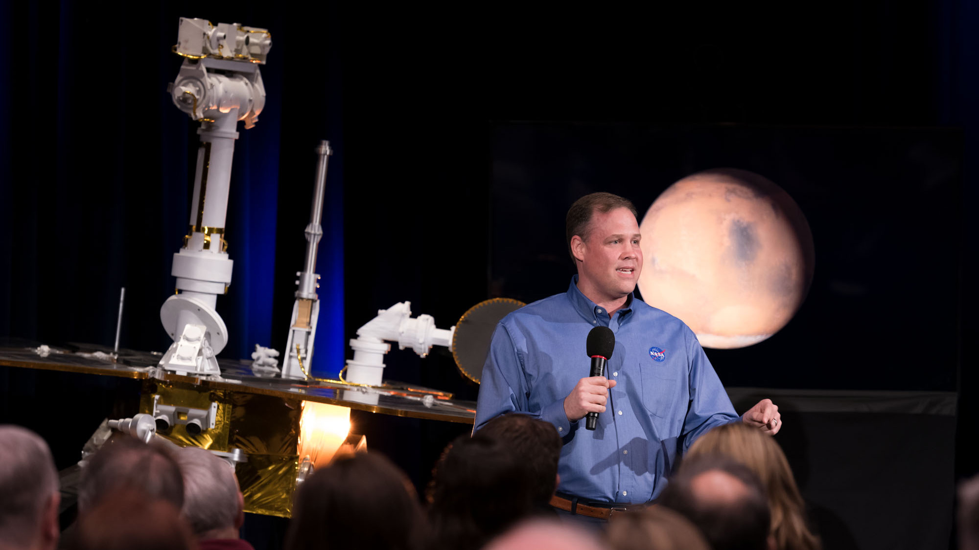 NASA Administrator Jim Bridenstine discusses the successful completion of the Opportunity Mars rover mission during a news briefing at the agency's Jet Propulsion Laboratory in Pasadena, California. Behind him to the left is a model of Opportunity and to the right behind him is an image of Mars.