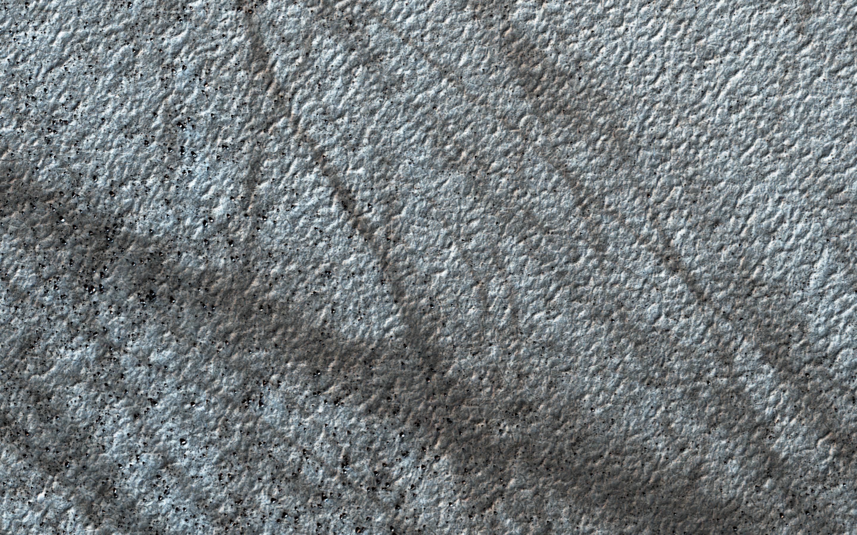 This image acquired on January 13, 2019 by NASAs Mars Reconnaissance Orbiter, shows a cluster of dust devil tracks on the flat ground below the south polar layered deposits, but none on the layers themselves.