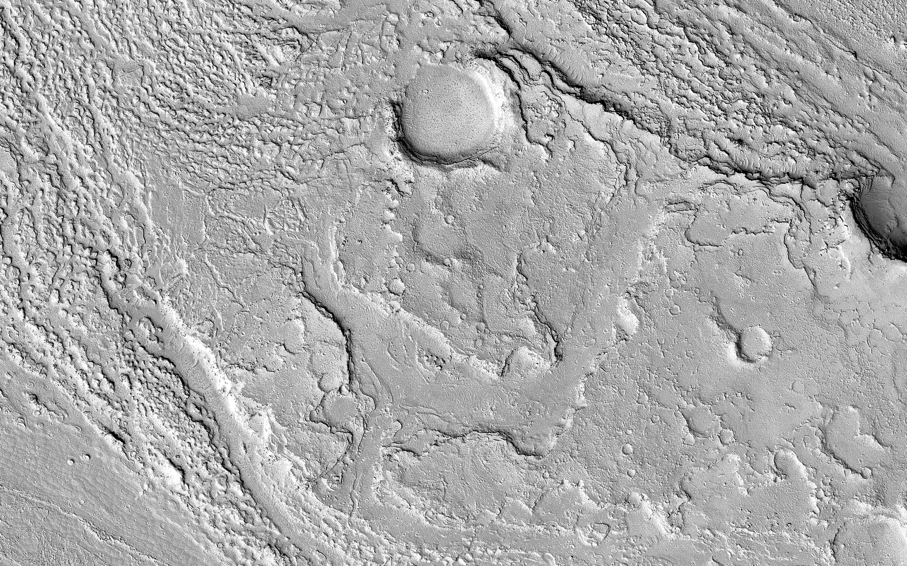 This image acquired on December 9, 2018 by NASAs Mars Reconnaissance Orbiter, shows Athabasca Valles with lava flows originating from Elysium Mons to the northwest.